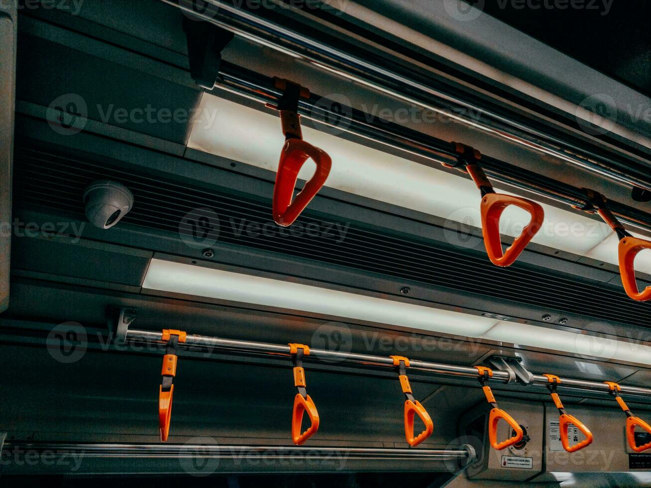 Empty yellow handle grip on public transportation photo