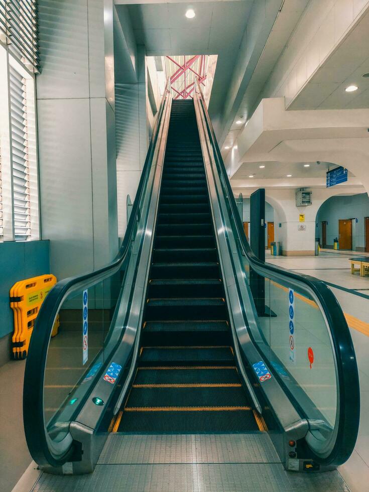 Empty escalator stairs in the public building. photo