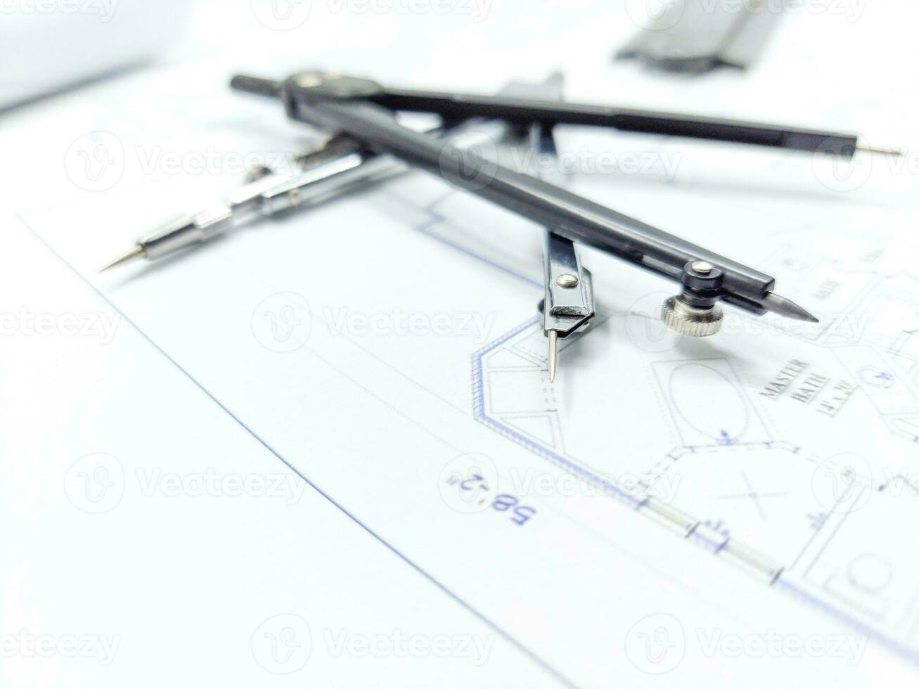 Paper home floor plan with compass. Architectural sketching process concept. Floor plan on architect's desk. photo
