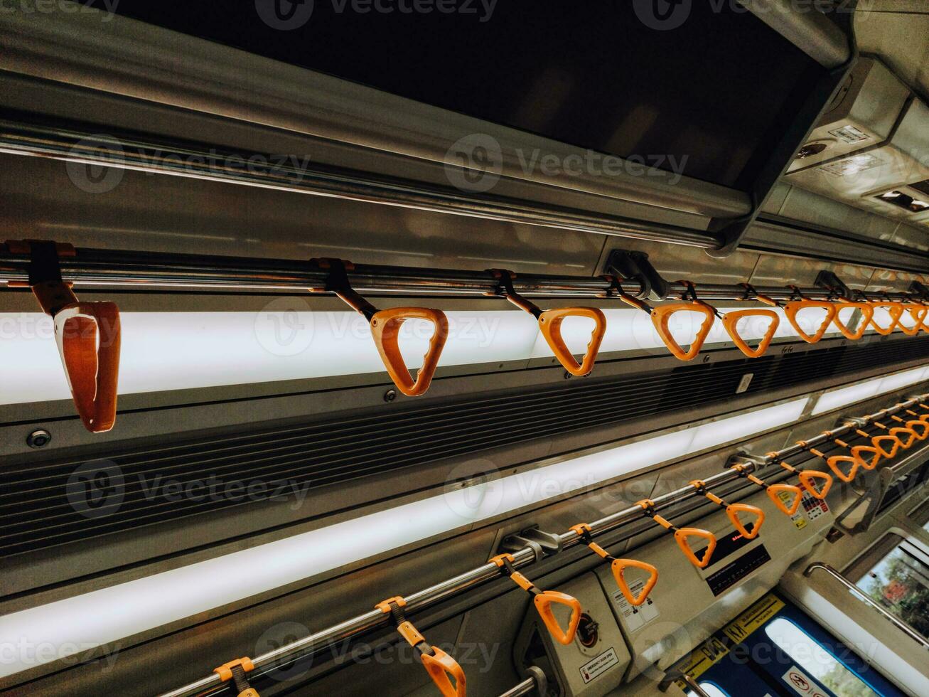 Empty yellow handle grip on public transportation photo