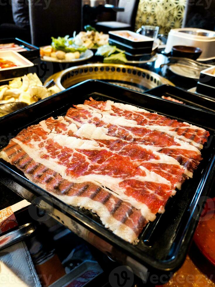 Raw beef slice for barbecue or Japanese style yakiniku photo