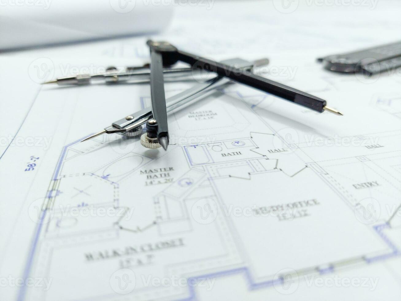 Paper home floor plan with compass. Architectural sketching process concept. Floor plan on architect's desk. photo