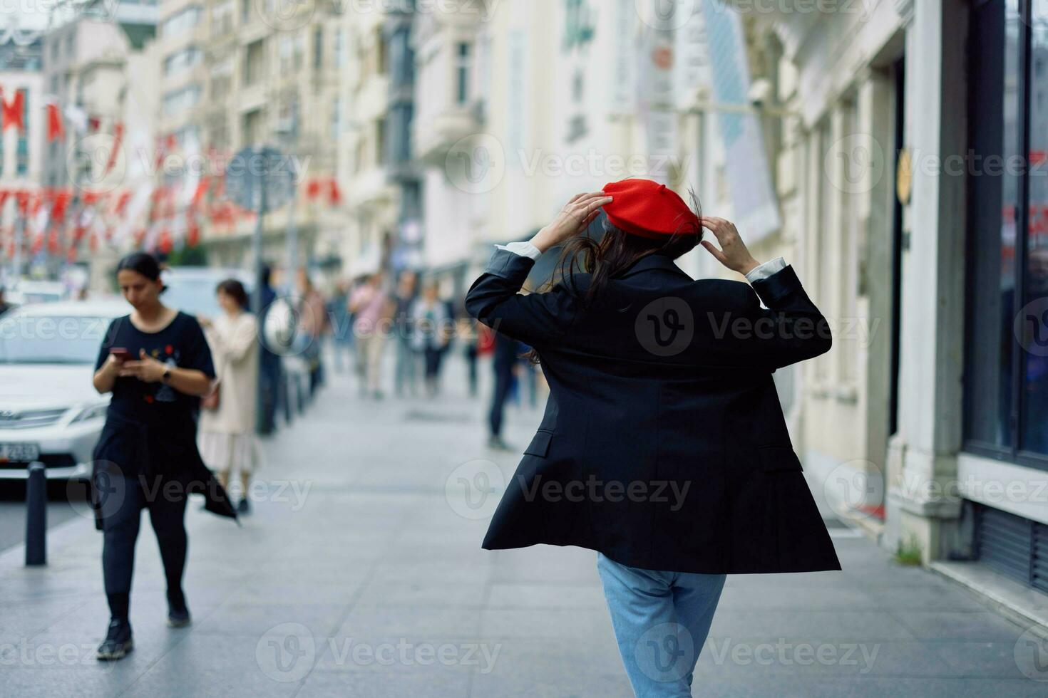 Happiness woman jumps and runs, follow me walks walks in the city against the backdrop of office buildings, stylish fashionable vintage clothes and make-up, spring walk, travel. photo