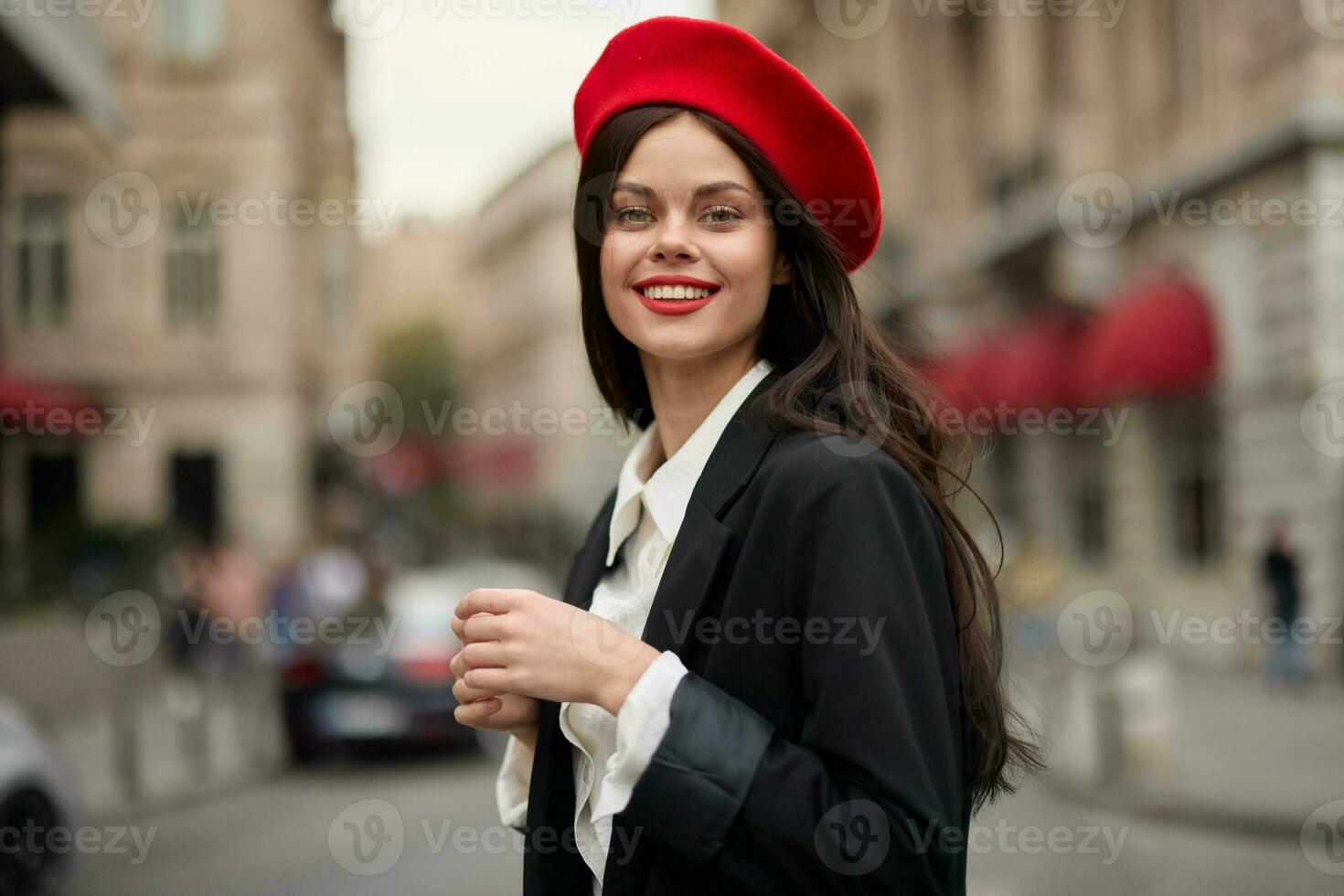 Fashion woman portrait smile with teeth standing on the street in front of the city tourist in stylish clothes with red lips and red beret, travel, cinematic color, retro vintage style, urban fashion. photo