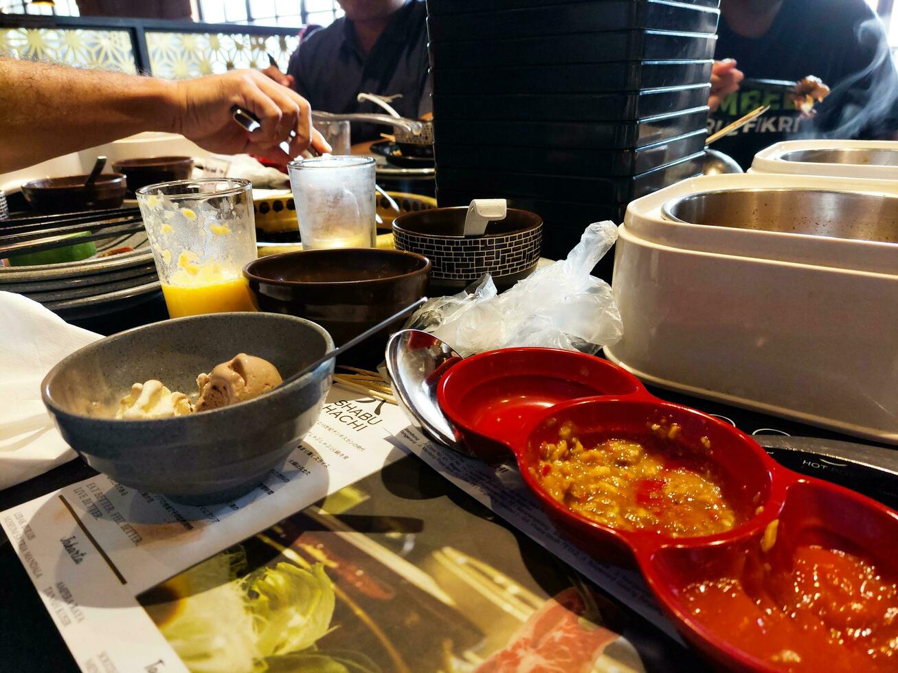 Empty dirty plates with spoons and forks on the table after meal. Banquet ending concept. Unwashed dishes ready to cleaning at Japanese restaurant photo