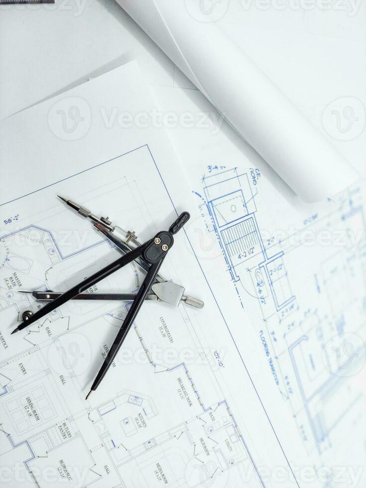 Paper home floor plan with compass. Architectural sketching process concept. Floor plan on architect's desk. photo
