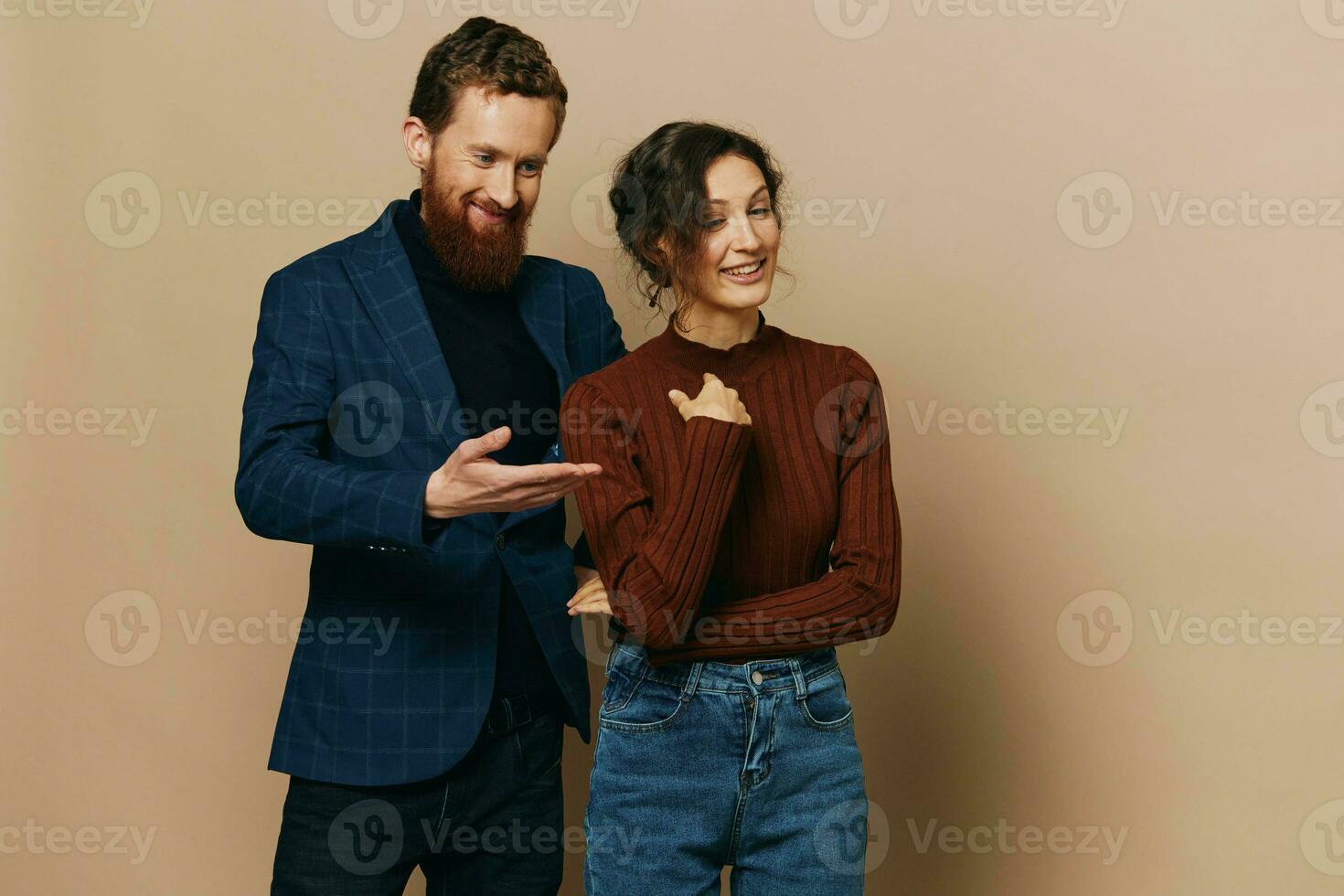 Man and woman couple in a relationship smile and interaction on a beige background in a real relationship between people photo