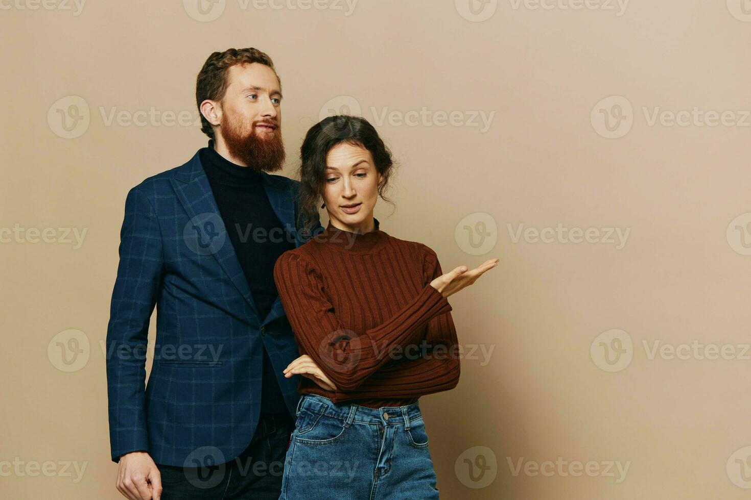 Man and woman couple in a relationship smile and interaction on a beige background in a real relationship between people photo