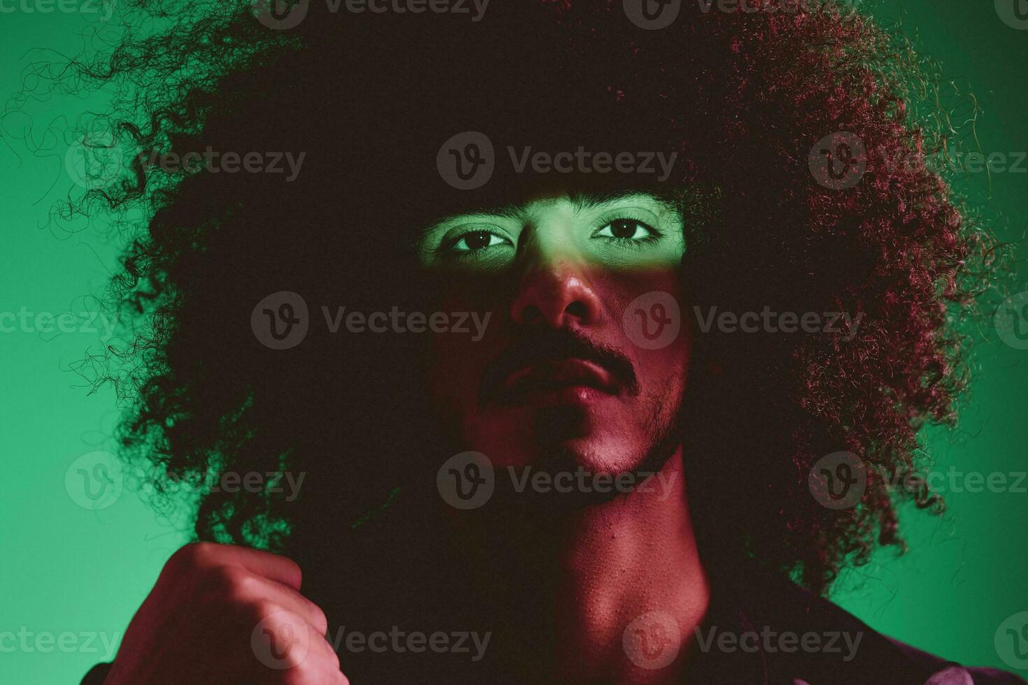 Portrait of a stylish man in a jacket on a green background multinational, color light, trend photo