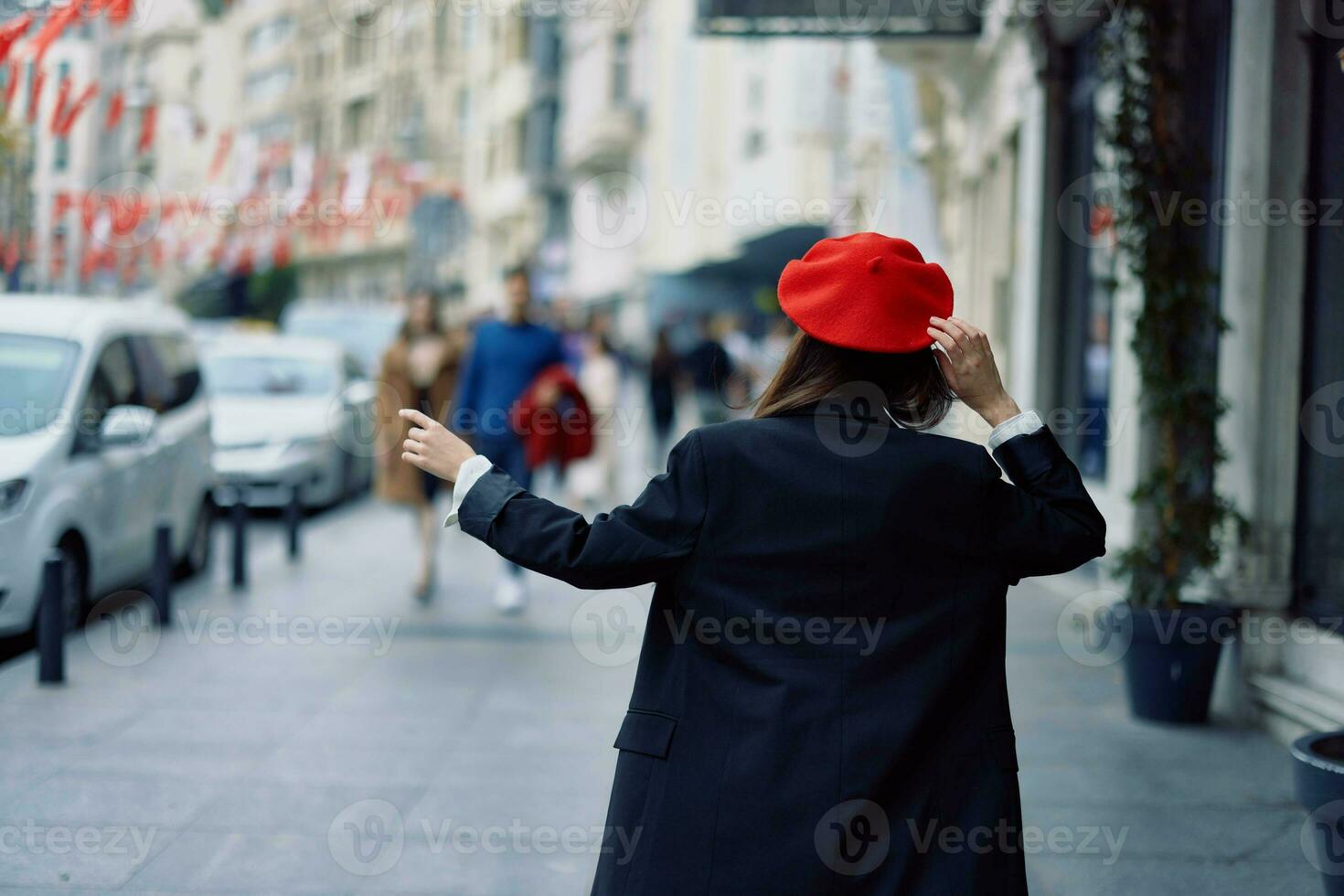 Woman happiness view from the back, follow me walks walks in the city against the backdrop of office buildings, stylish fashionable vintage clothes and makeup, spring walk, travel. photo