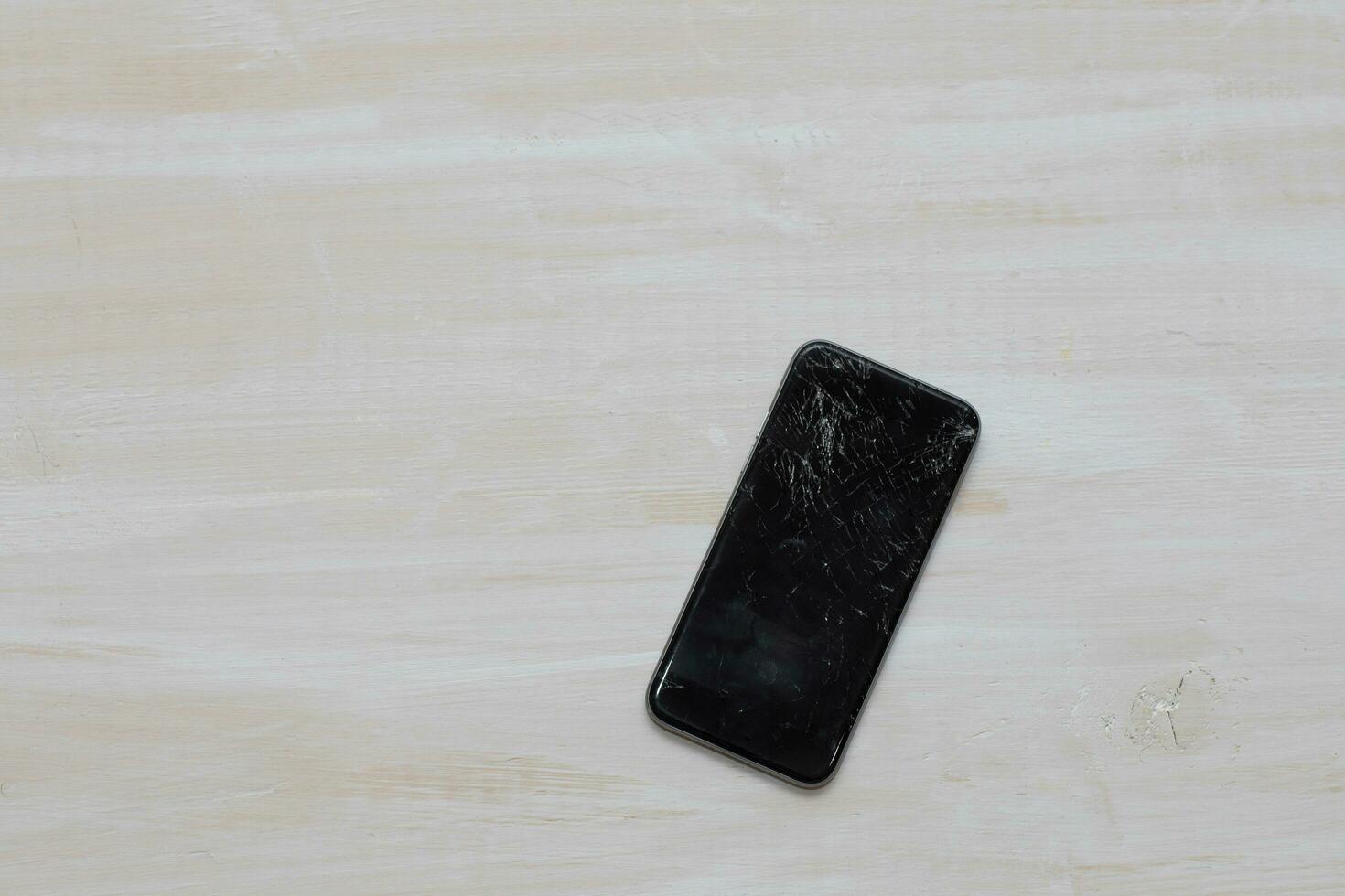 Broken glass of a black smartphone. photo