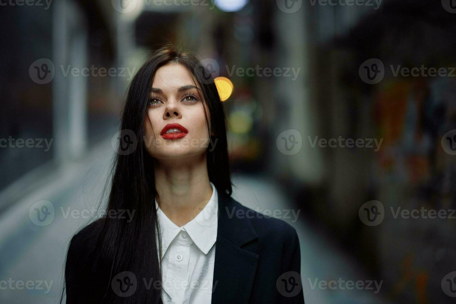 Fashion woman dramatic portrait tourist in stylish clothes in jacket and red beret walking down narrow city street flying hair, travel, French style, cinematic color, retro vintage style. photo