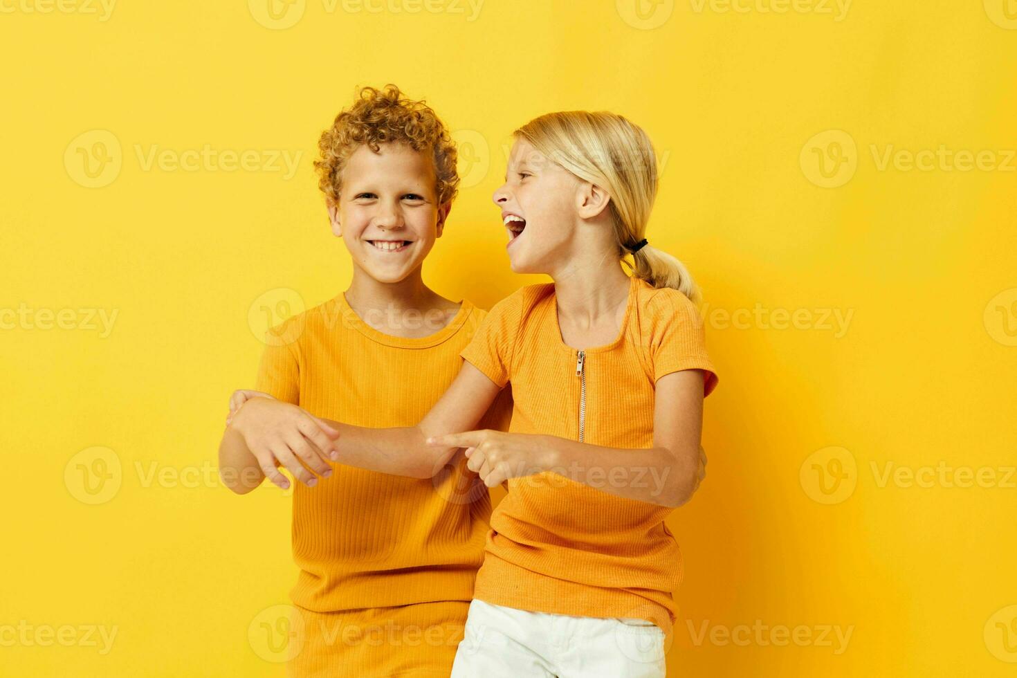 Cute preschool kids cuddling fashion childhood entertainment yellow background unaltered photo