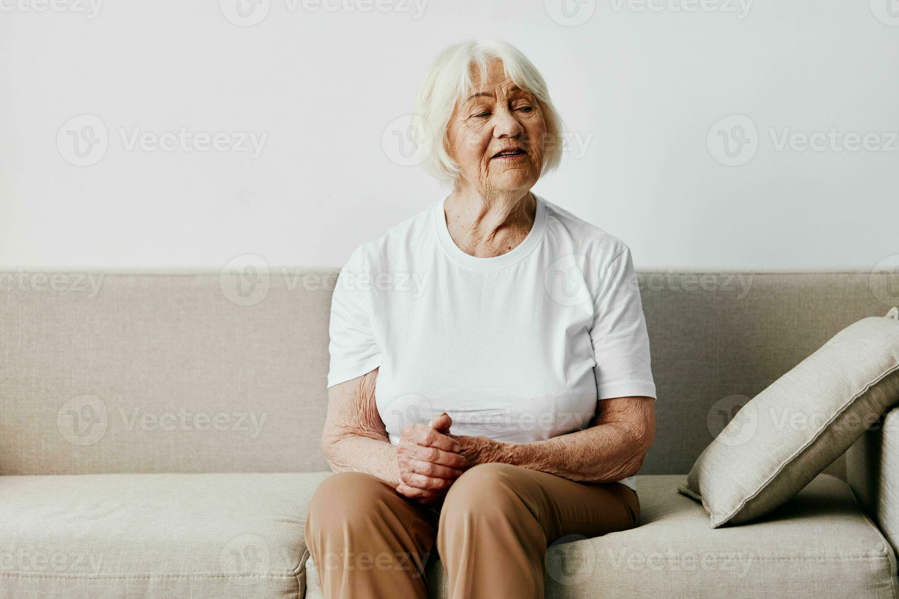 Bearded elderly man wearing beige trousers and sneakers sitting near wife  Stock Photo  Alamy