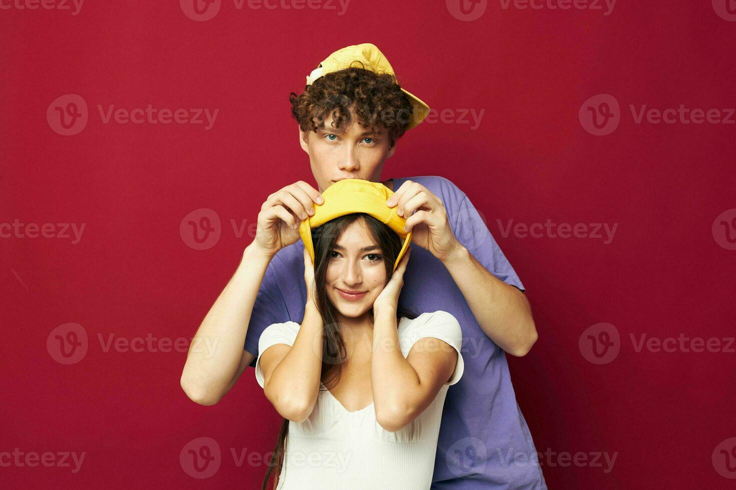 nice guy and girl stand side by side fashion modern style home fun red background photo