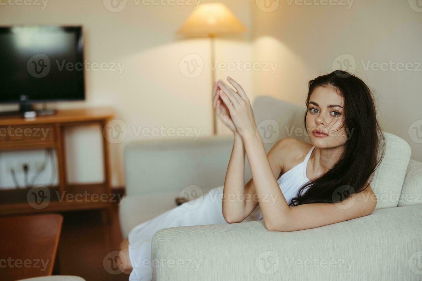 Happy girl smile lying on the couch at home, relaxing at home, comfort, sunshine. photo