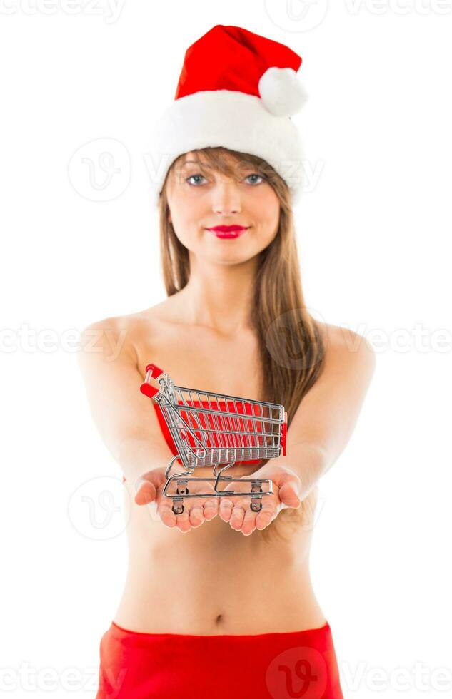 Beautiful Santa christmas girl with small shopping trolley on white photo