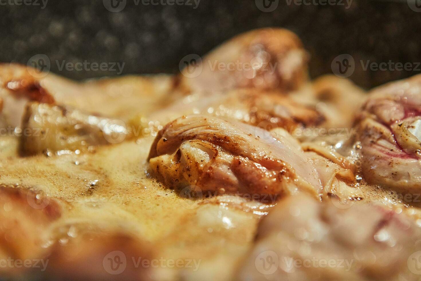 Chicken legs fried in pan on gas stove. photo