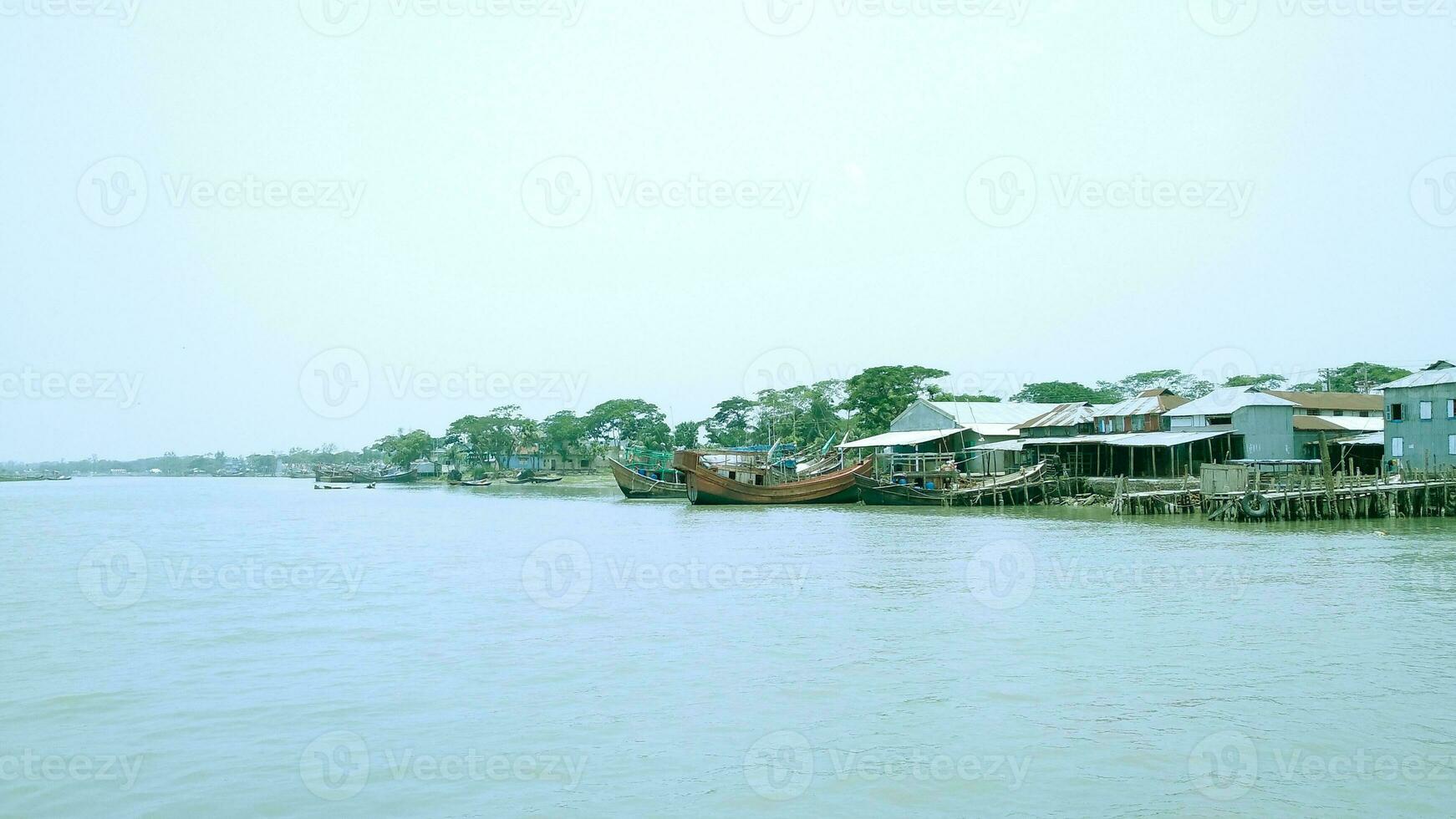 In rural areas of Bangladesh, Boat, river and green tree photo