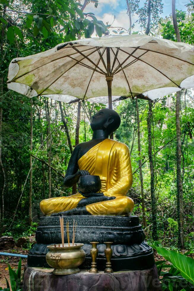 Statue of a monk Pra Upakhut photo