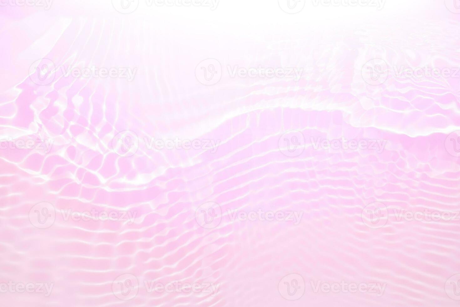 Purple water with ripples on the surface. Defocus blurred transparent pink colored clear calm water surface texture with splashes and bubbles. Water waves with shining pattern texture background photo