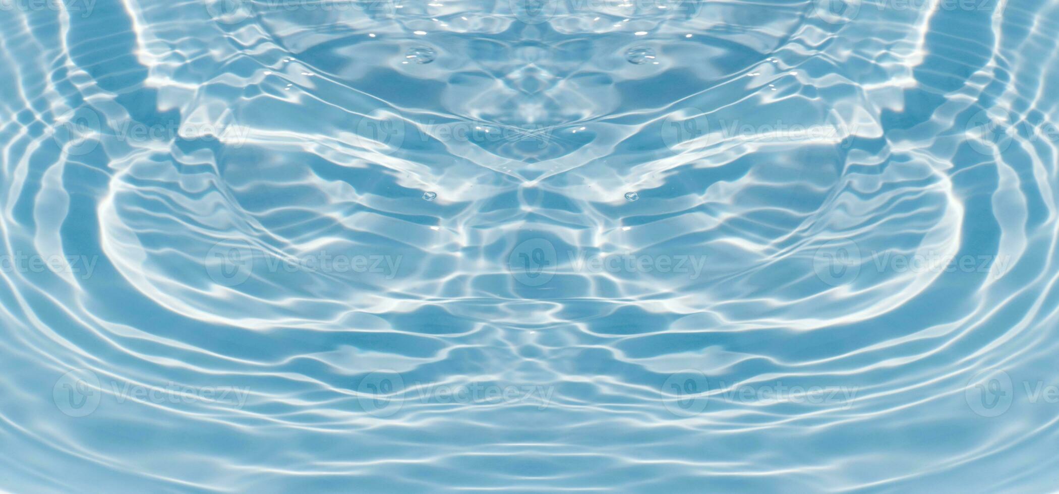 Blue water with ripples on the surface. Defocus blurred transparent blue colored clear calm water surface texture with splashes and bubbles. Water waves with shining pattern texture background. photo