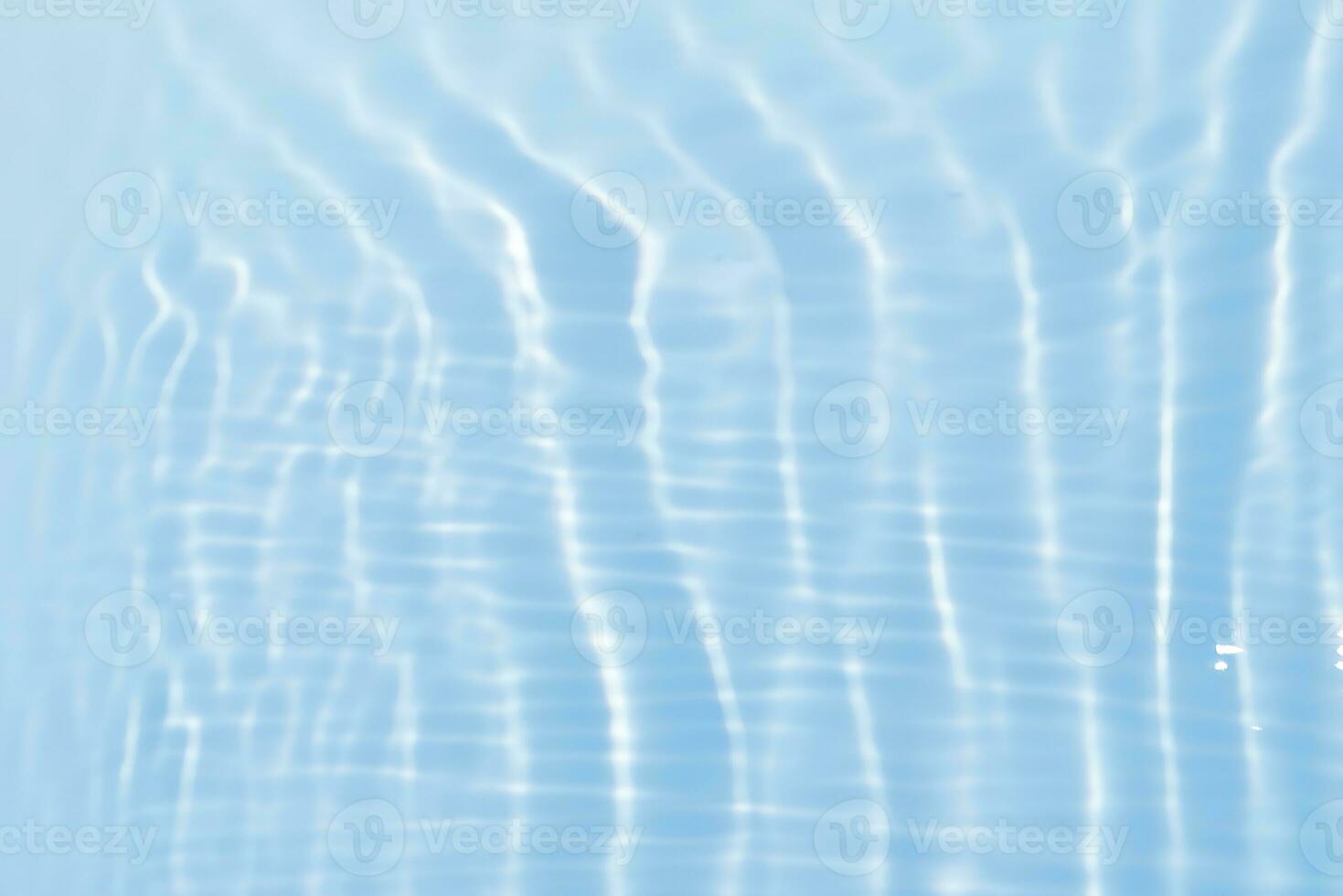 Blue water with ripples on the surface. Defocus blurred transparent blue colored clear calm water surface texture with splashes and bubbles. Water waves with shining pattern texture background. photo