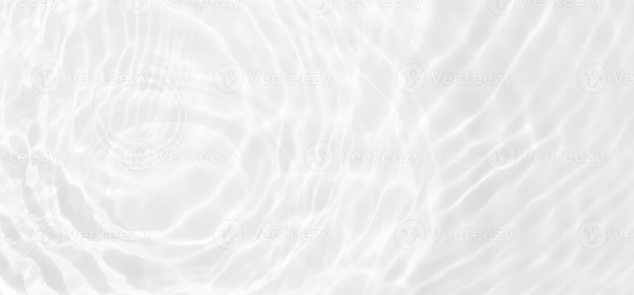 White water with ripples on the surface. Defocus blurred transparent white colored clear calm water surface texture with splashes and bubbles. Water waves with shining pattern texture background. photo