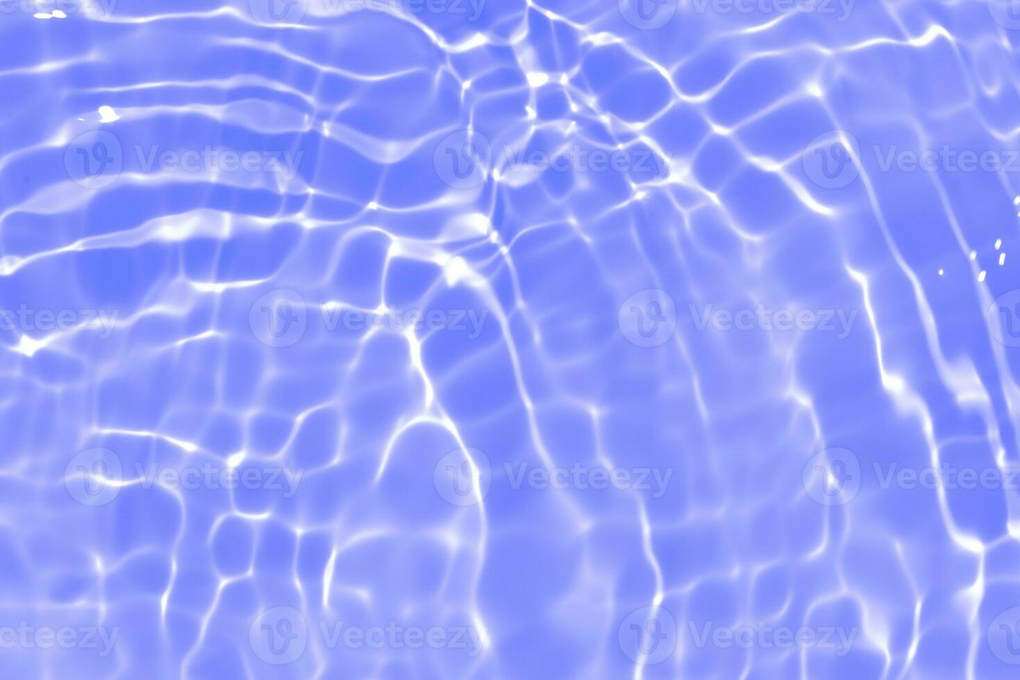 Purple water with ripples on the surface. Defocus blurred transparent pink colored clear calm water surface texture with splashes and bubbles. Water waves with shining pattern texture background. photo