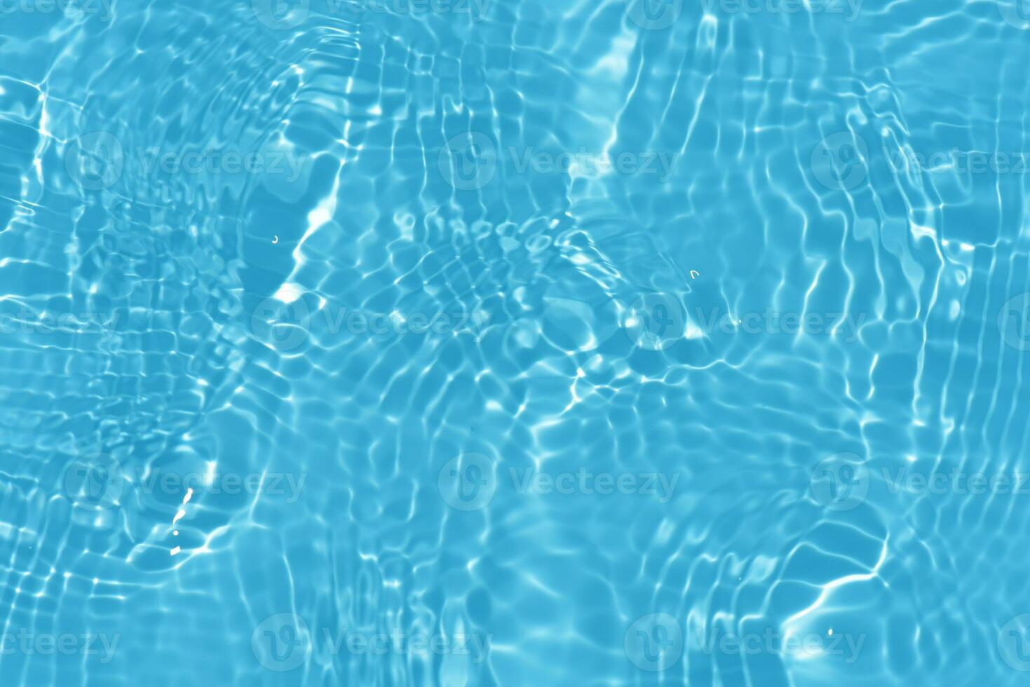 Blue water with ripples on the surface. Defocus blurred transparent blue colored clear calm water surface texture with splashes and bubbles. Water waves with shining pattern texture background. photo