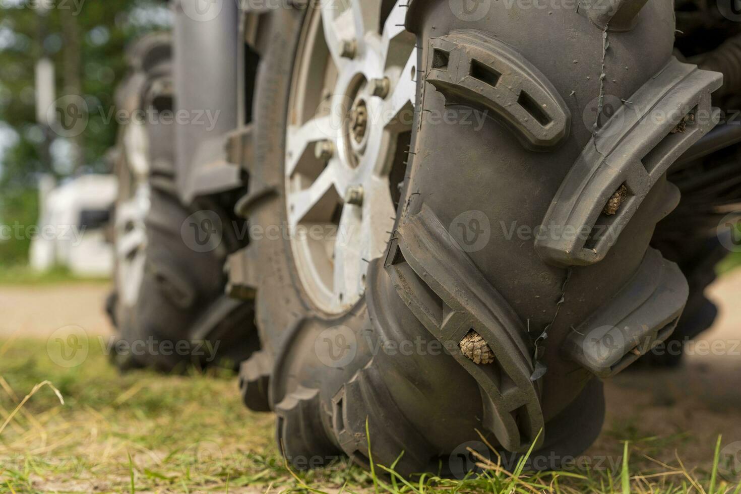 Close-up of the ATV wheel on sandy ground. photo