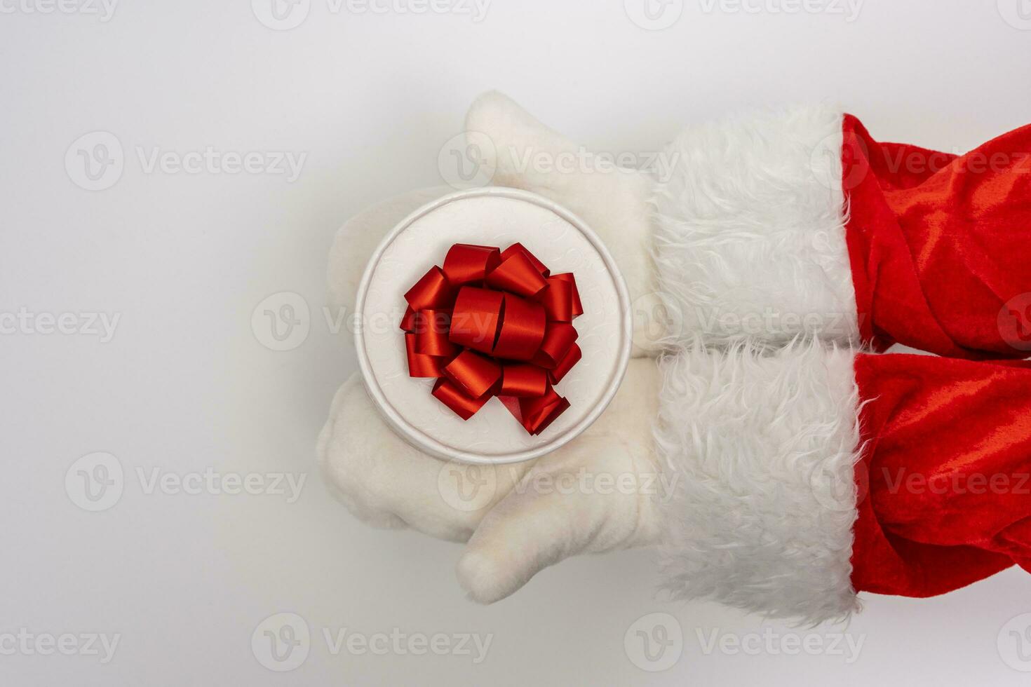 Santa's hands are holding a gift for Christmas. white background photo