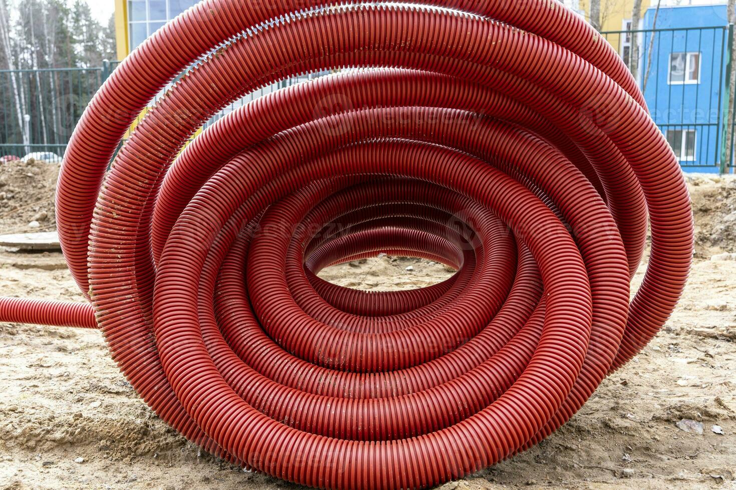 rolled up red corrugated PVC pipe for laying electrical cables 25060299 Stock Photo at Vecteezy