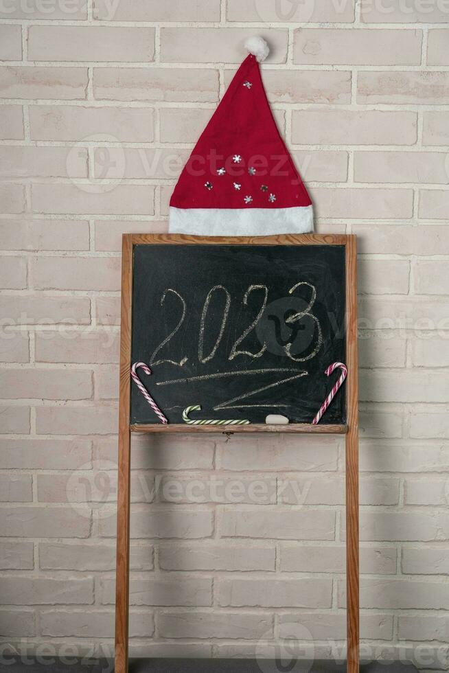 a black slate on which the year 2023 is written in chalk. Happy New Year. photo