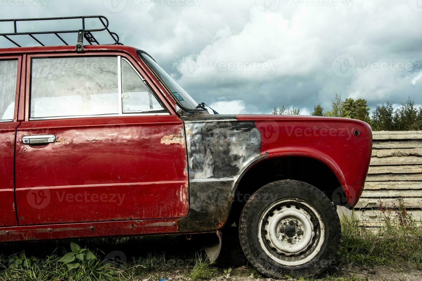 an old broken classic car abandoned on the street. stainless old machine photo