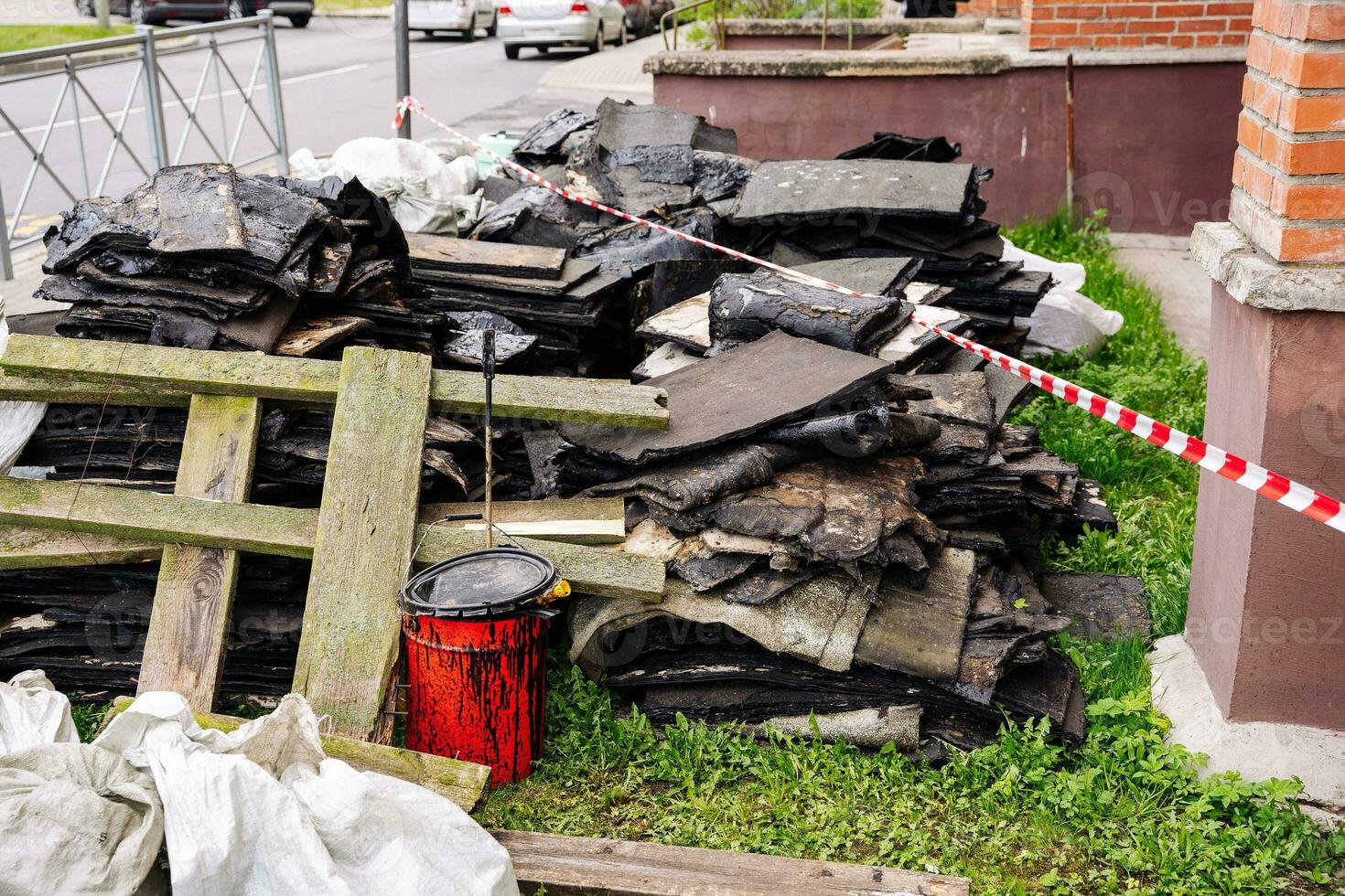 debris left after the repair of the roof. red bucket with mastic photo