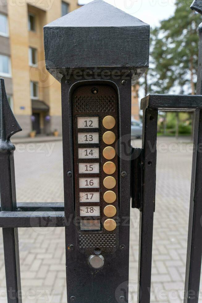 intercom panel with a video camera on the brick fence of private house photo