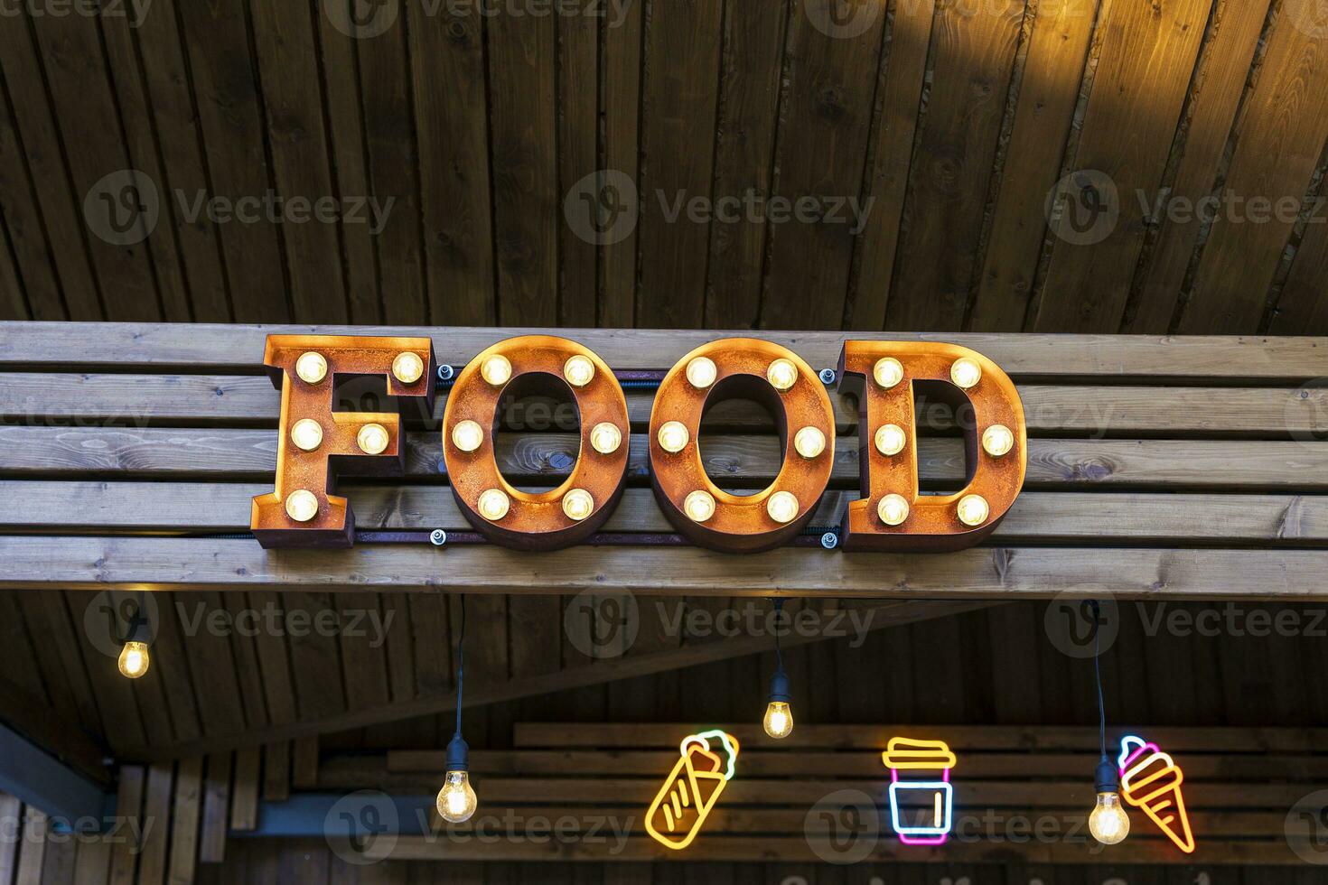 the glowing street sign of the FOOD street cafe photo