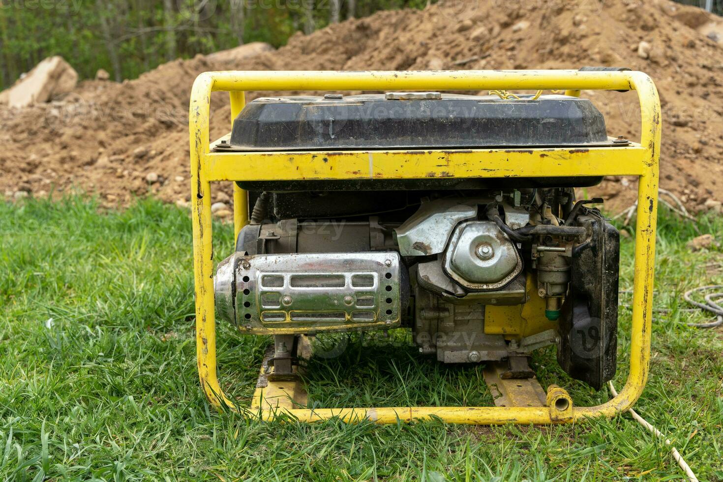 portable gasoline generator operating on a construction site photo
