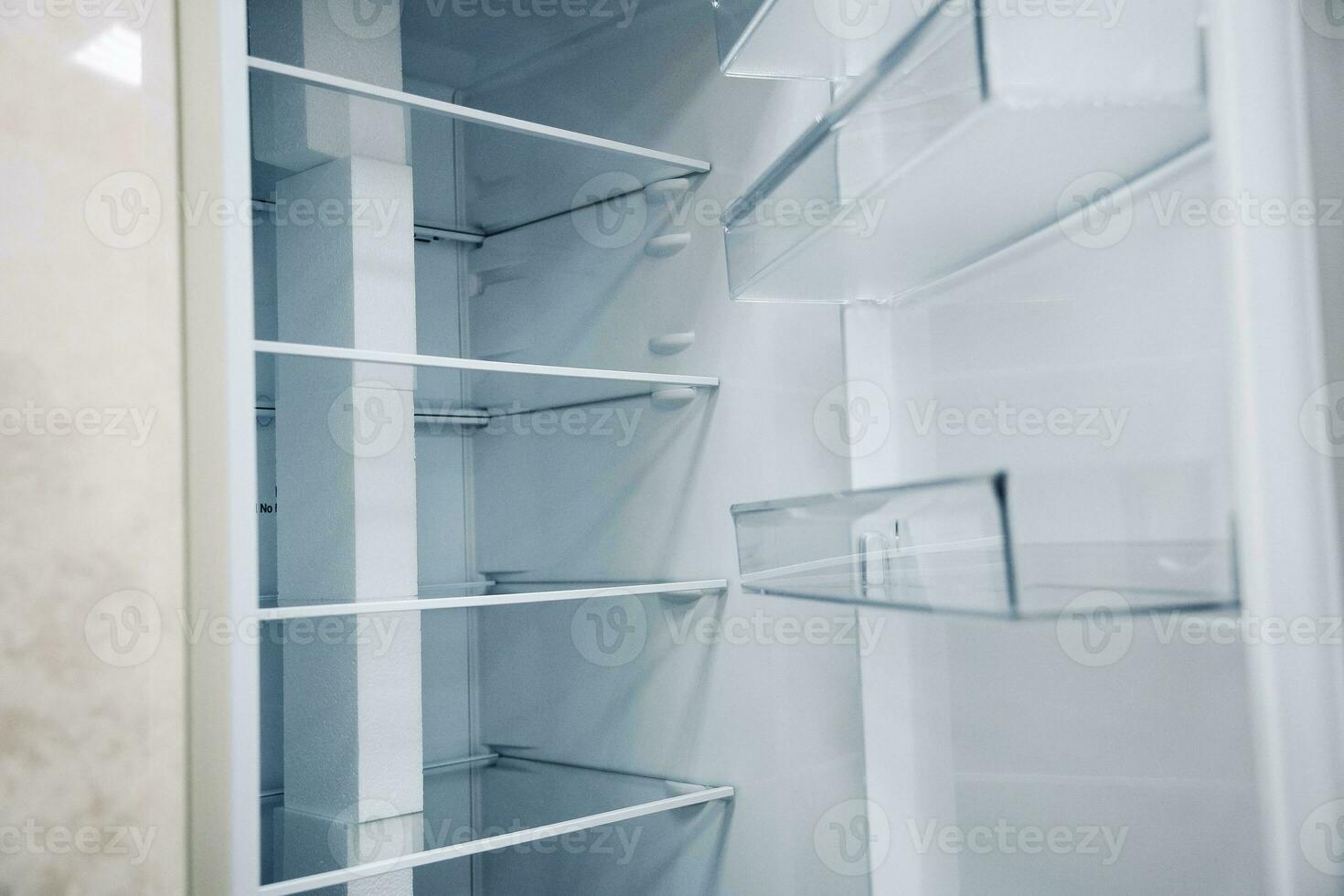 empty shelves of an open refrigerator. a new refrigerator photo