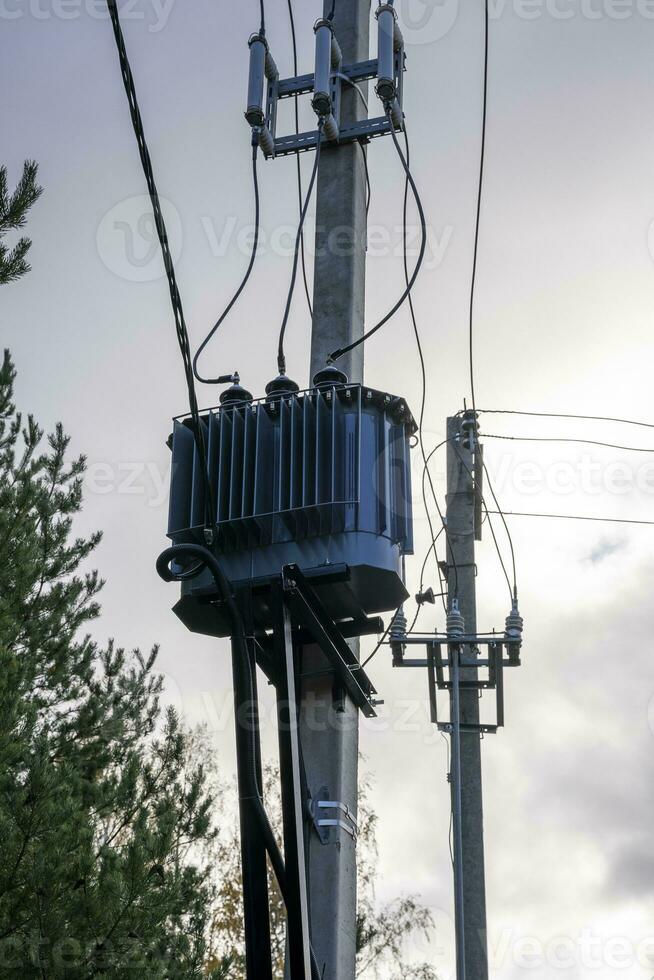 network transformer installed and fixed on a reinforced concrete pole photo