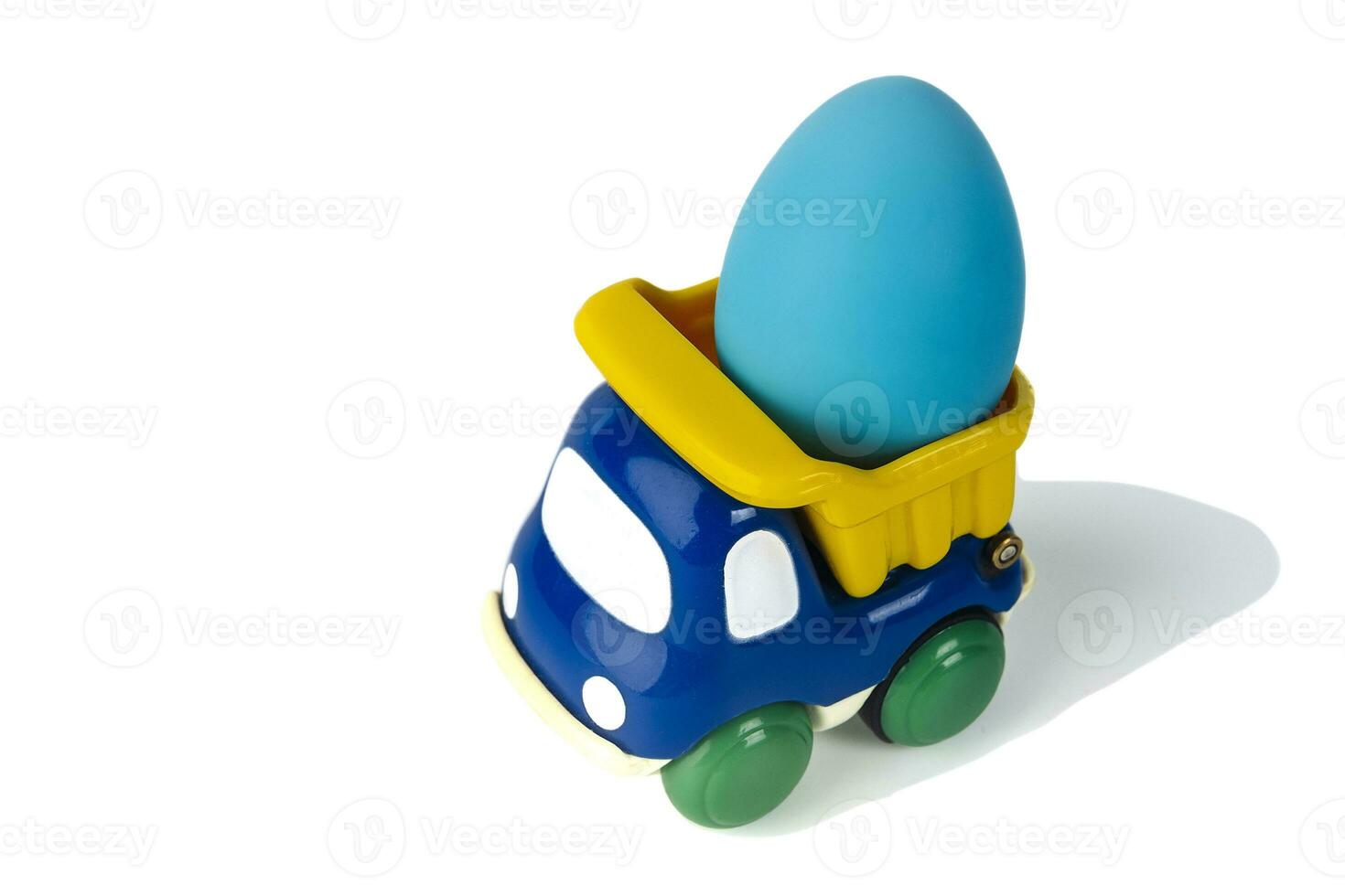 A toy children's dump truck transports an Easter gift egg photo