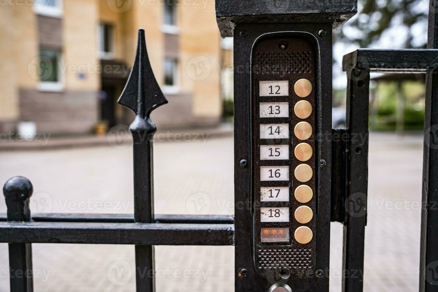 intercom panel with a video camera on the brick fence of private house photo