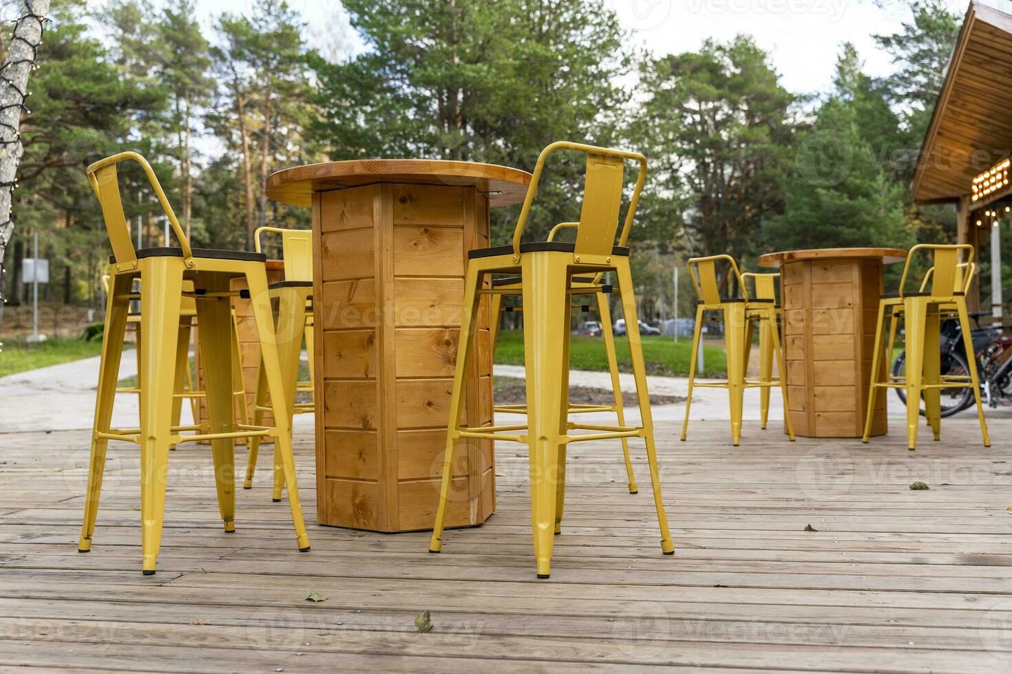 empty tables and chairs on the terrace of an outdoor outdoor cafe 25061065 Stock Photo at Vecteezy
