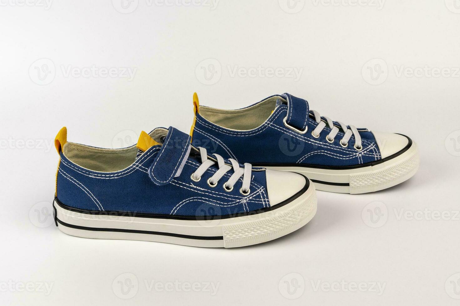 a pair of blue sneakers on a white background. Fashionable youth shoes photo