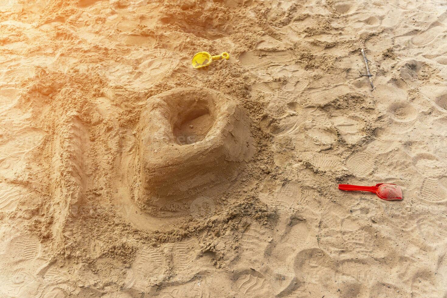 sand castle on the beach. a castle built by a child out of raw sand photo