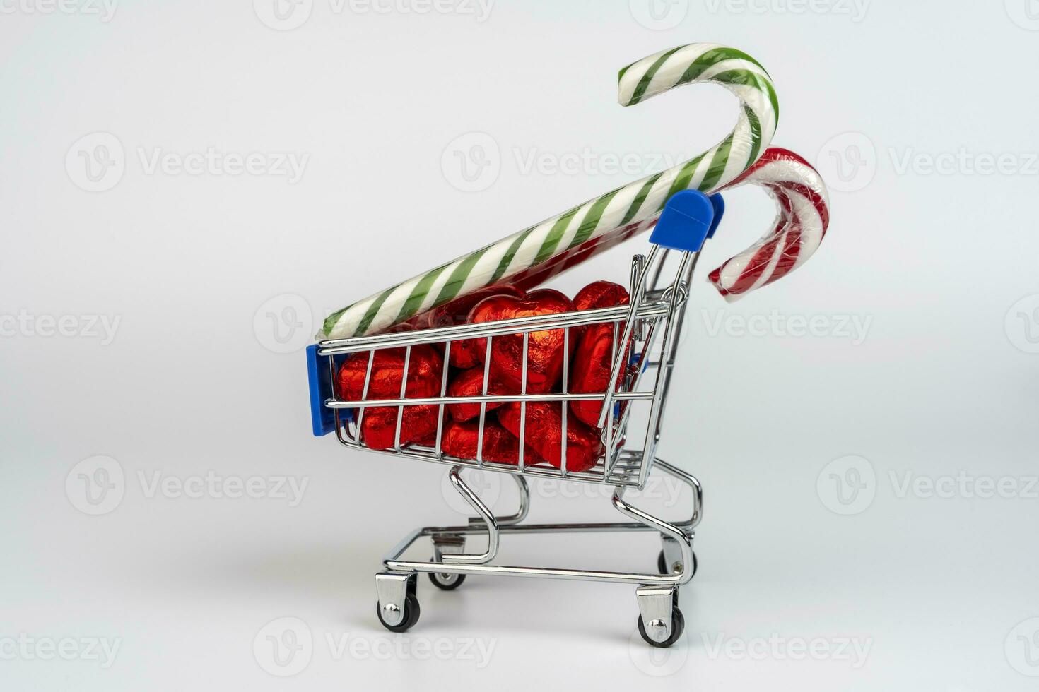 A supermarket trolley loaded with candies and Christmas caramel canes photo