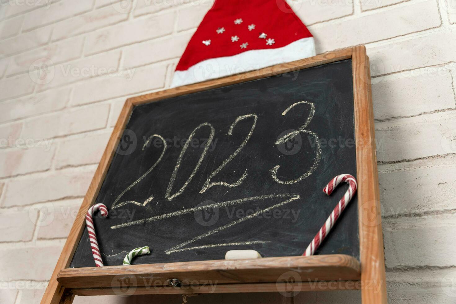 a black slate on which the year 2023 is written in chalk. Happy New Year. photo