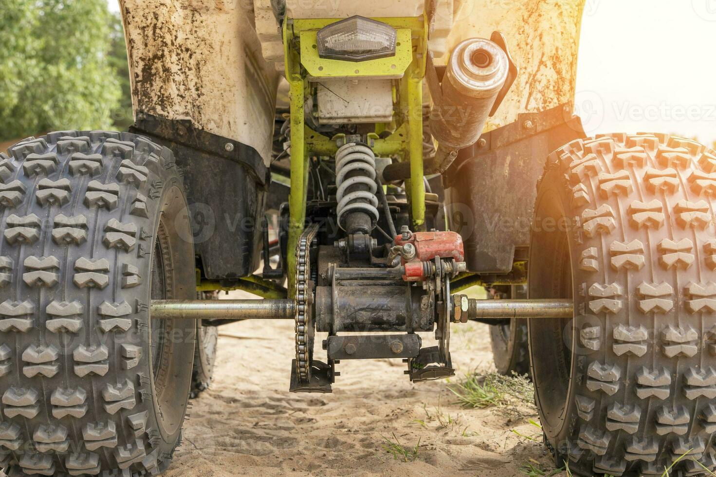 Rear view of the ATV standing on sandy ground photo