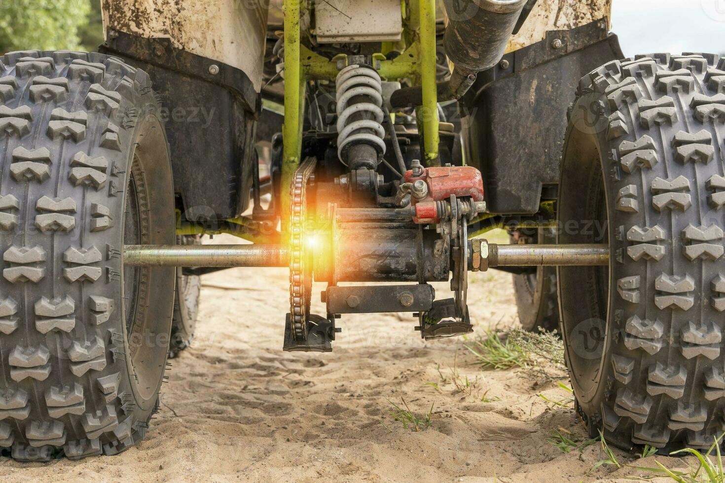 Rear view of the ATV standing on sandy ground photo